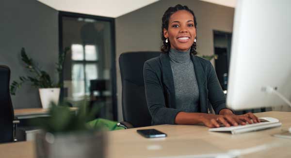 An assistant sitting at her desk.